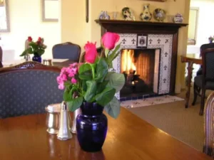 Flowers on the table near the fireplace in Patisserie Boissiere indoor sitting area